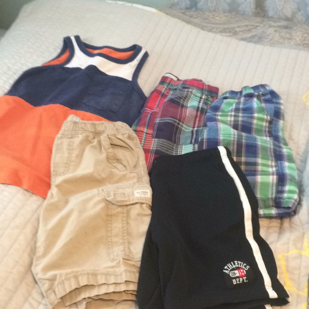 Four pairs of boys shorts and a tank top shirt